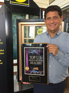 Steven J. DeMire Holding A Top US Door & Window Dealer Award