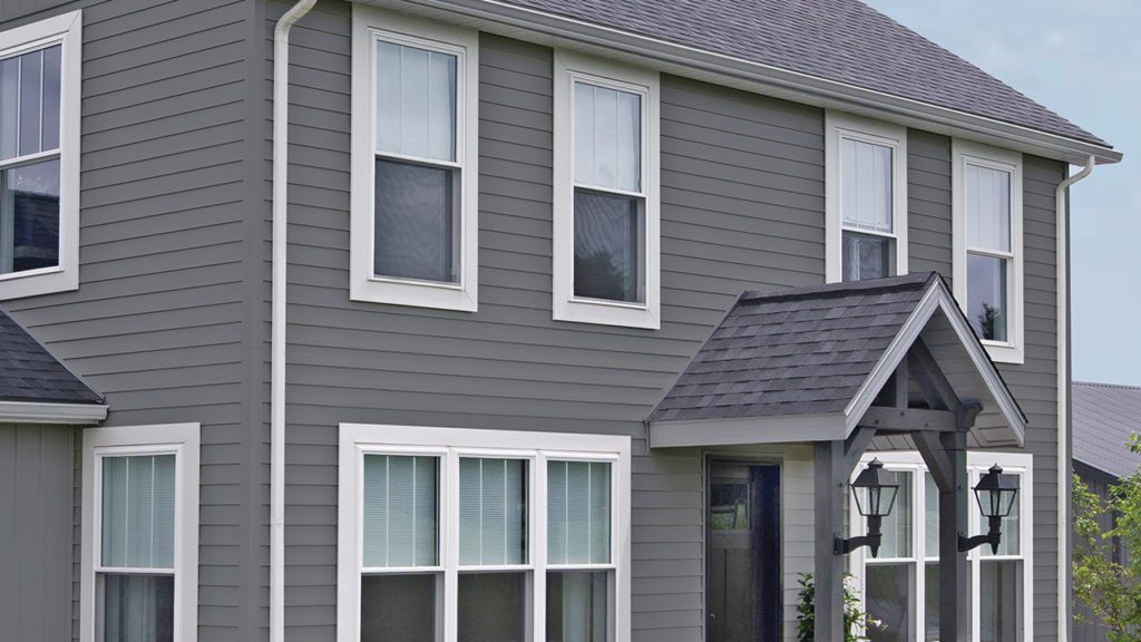 How to Clean Vinyl Siding in 3 Steps - Unified Home Remodeling Clean vinyl siding on a gray 2-story home.