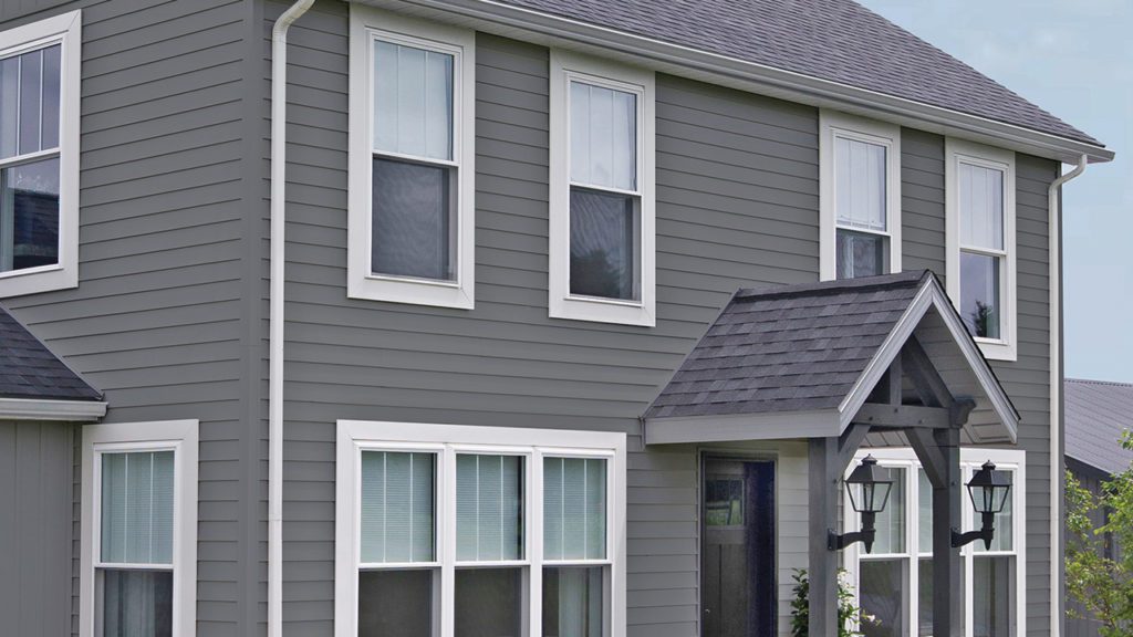 Clean vinyl siding on a gray 2-story home.