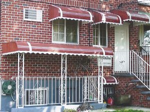 Awning Windows With White Frames On A Brick House