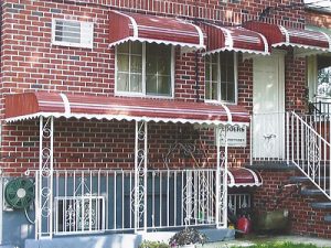 Awnings - Unified Home Remodeling Awning Windows With White Frames On A Brick House