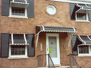 Awning Windows With White Frames On Brick Home