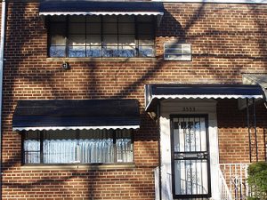 Awnings - Unified Home Remodeling Awning Windows With Black Frames On Brick Home
