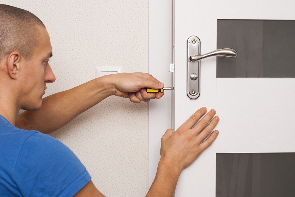 Man performing interior door maintenance.