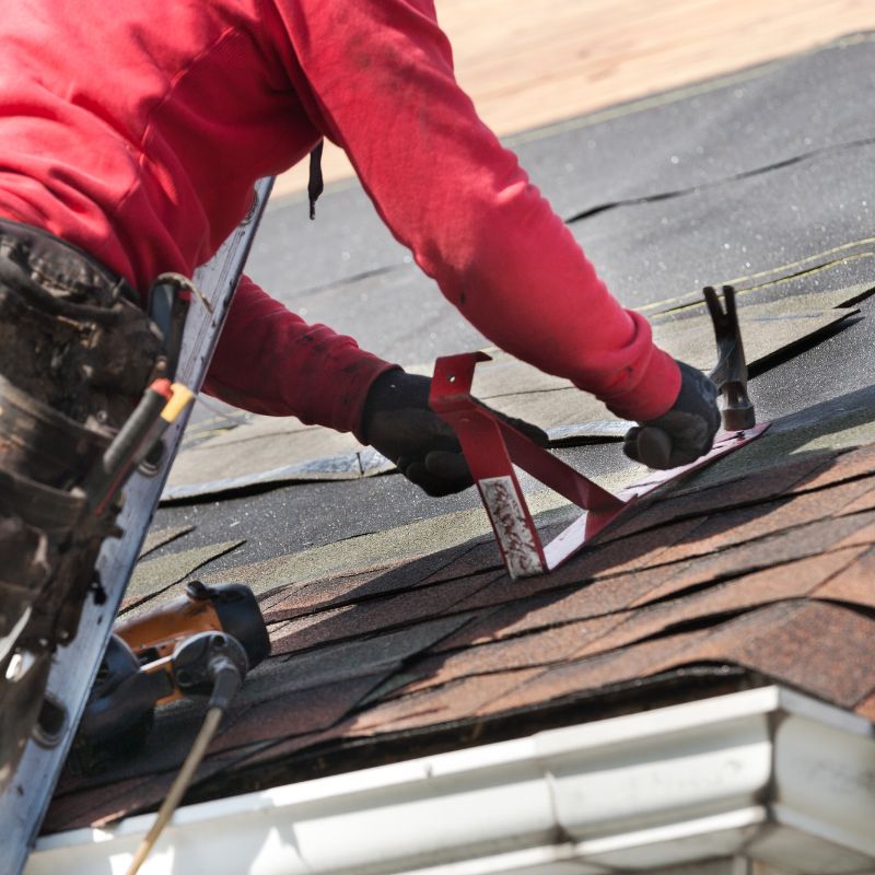 Long Island Roofing - Unified Home Remodeling A roofer on a Long Island, NY home