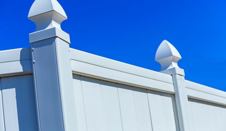 White vinyl fences provide security for a commercial property on Long Island