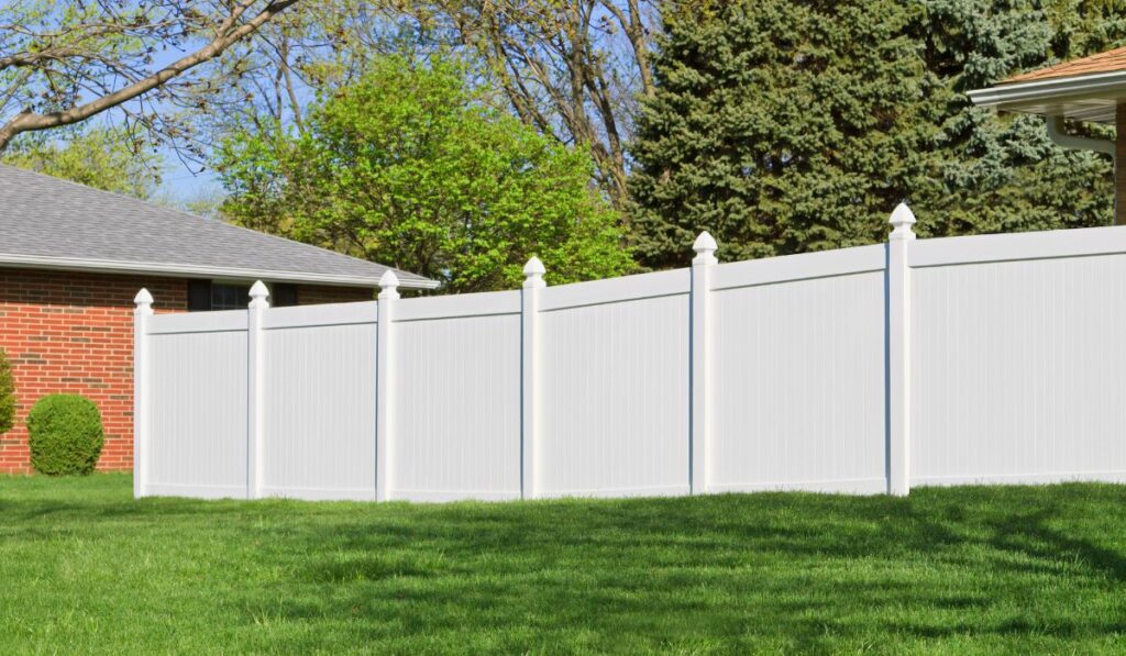 A sturdy, elegant vinyl fence enduring the diverse climate of Long Island, symbolizing resilience and style.
