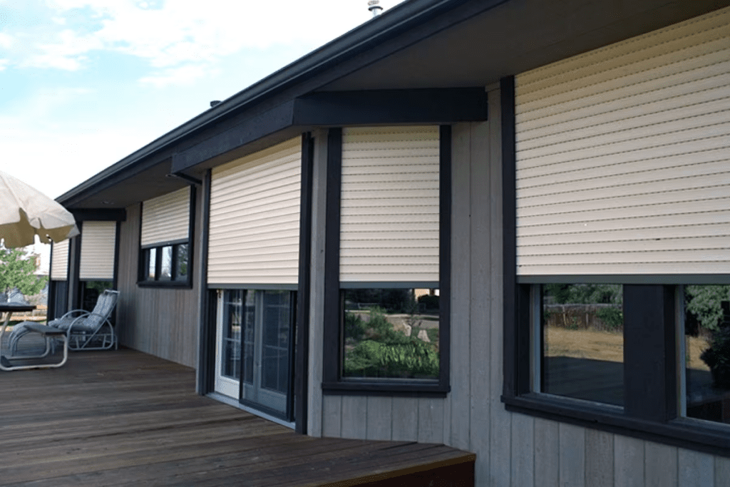 a home "hardened" with roll-up  shutters to protect windows from storm damage