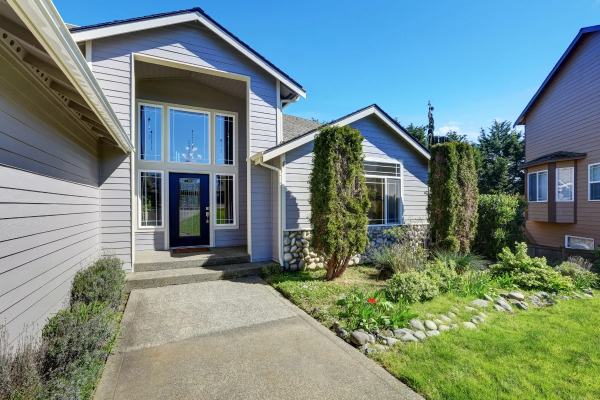 Blue Certainteed siding on a Long Island house with elegant front door and side windows