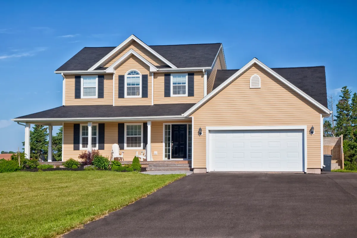 Sand Dunes Color on Two-Story Home Two-story home with LP SmartSide siding in Sand Dunes color, white trim, and black shutters, used for an LP SmartSide Siding Review