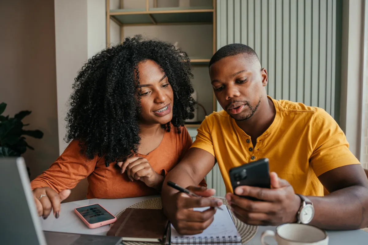 Couple reviewing financing options for roofing, siding, or window replacement in their Long Island home