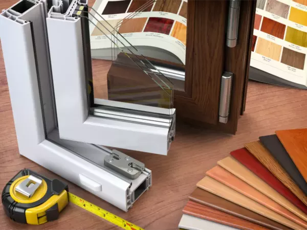 Replacement window frame, glass panes, measuring tape, and finish samples for a Long Island window project