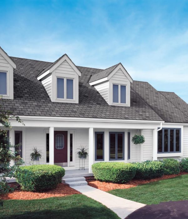 xterior home remodeling project in Nassau County featuring asphalt shingle roofing, vinyl siding, and energy-efficient window replacement.