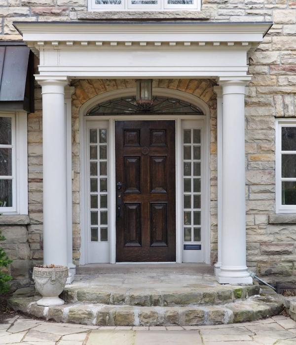 Custom portico and entry door installation on a suburban home