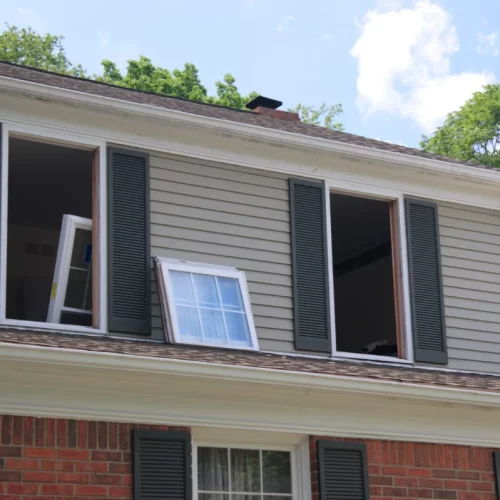 A home with windows removed and energy-efficient replacement windows ready to be installed - an effective way to cut energy costs.
